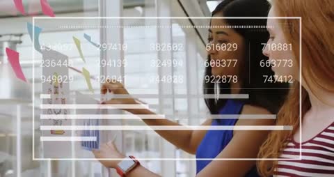 Colleagues Analyzing Data and Aligning Plan on Transparent Wall