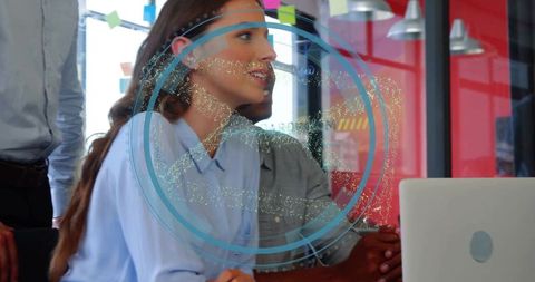 Businesswoman Pointing at Holographic Display in Meeting Room