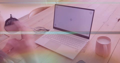 Woman's Hand Stirring Coffee in Cozy Home Office Setting