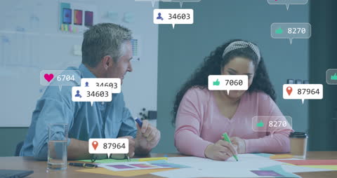 Two Colleagues Discussing Analytics with Social Media Icons Overlay