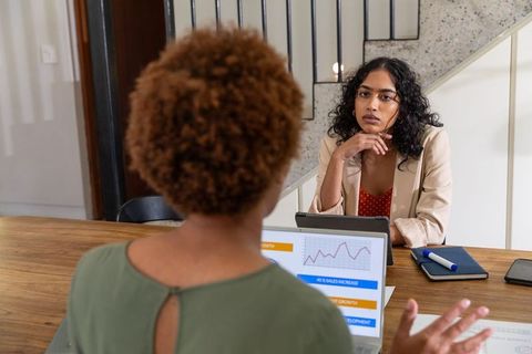Female Coworkers Discussing Business Strategy in Office