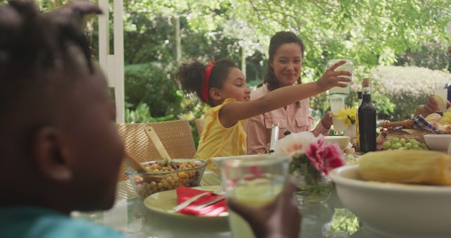 Family Enjoying Outdoor Meal Together in a Garden - Download Free Stock Images Pikwizard.com