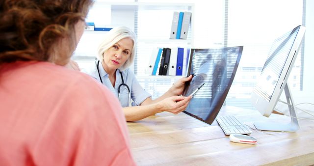 Doctor Consulting Patient with X-Ray in Medical Office - Download Free Stock Images Pikwizard.com