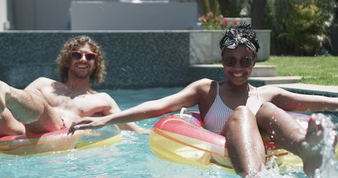 Young Couple Relaxing on Floaties in Sunny Pool - Download Free Stock Images Pikwizard.com