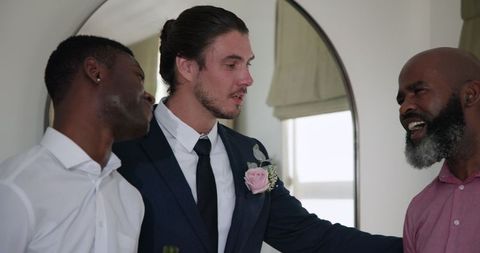 Groom delivering heartfelt speech among friends at wedding reception
