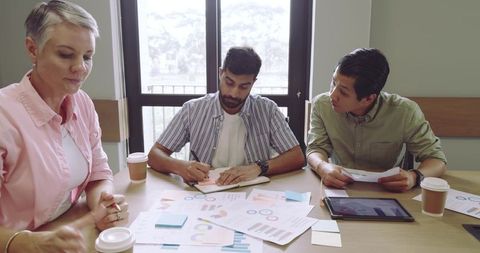 Diverse Team Analyzing Data and Brainstorming Strategies