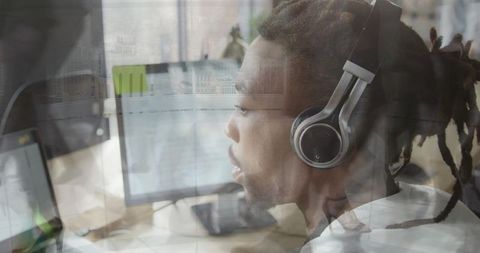Focused Man Working at Computer with Urban Reflections