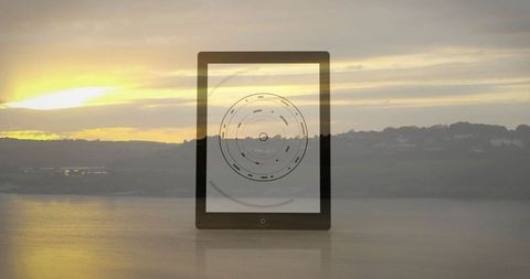 Futuristic tablet with circular radar display by lakeside