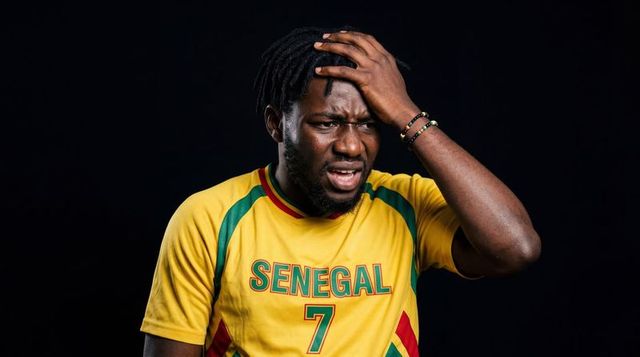 Frustrated senegal football fan clutching head wearing yellow #7 jersey
