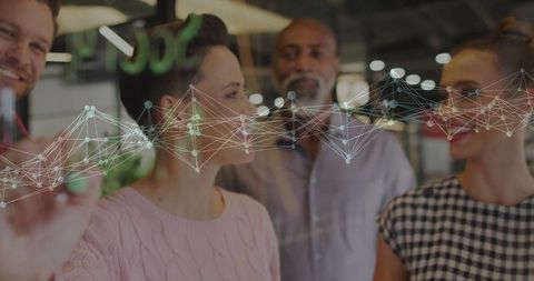 Colleagues Discussing Network Graph on Glass Board in Modern Office
