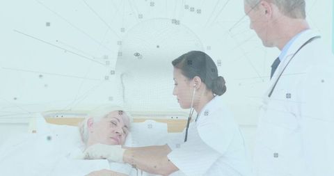 Asian Doctor Examining Senior Patient with Stethoscope in Hospital