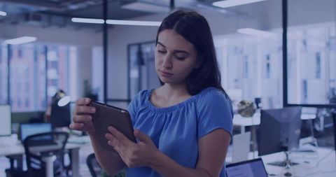 Focused Professional Examining Tablet in Modern Office