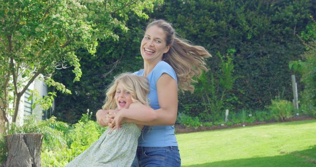 Happy Mother Playing with Daughter in Garden - Download Free Stock Images Pikwizard.com