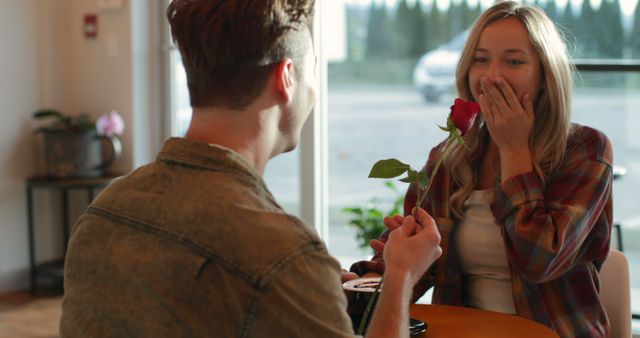 Man Giving Rose to Surprised Woman in Cafe - Download Free Stock Images Pikwizard.com
