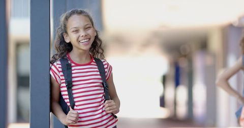 Smiling Young Girl with Backpack During School Break