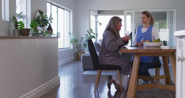 Senior woman taking pills while sitting at home - Download Free Stock Photos Pikwizard.com