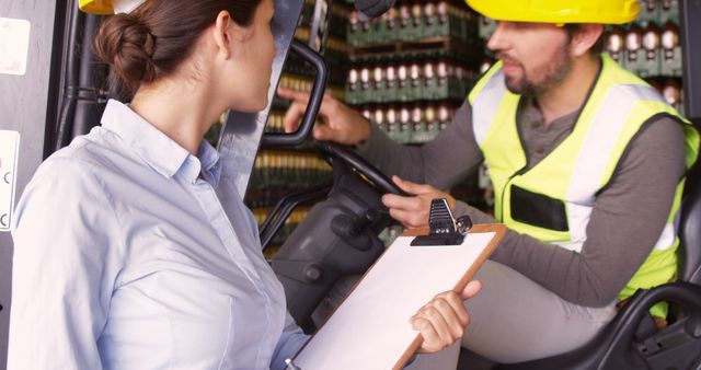 Warehouse Supervisor Checking Forklift Operator with Clipboard - Download Free Stock Images Pikwizard.com