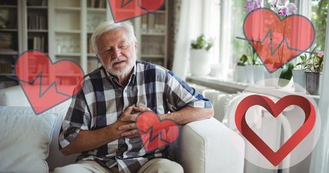Senior man experiencing chest pain with heart health icons