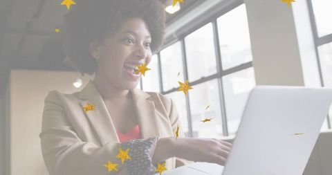 Excited professional woman celebrating success at modern workplace