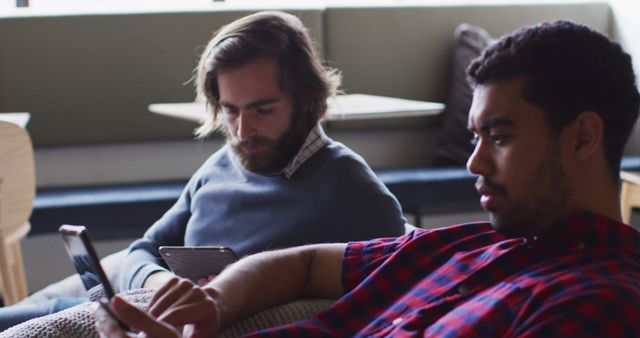 Two Men Using Mobile Devices in Modern Cafe Setting - Download Free Stock Images Pikwizard.com