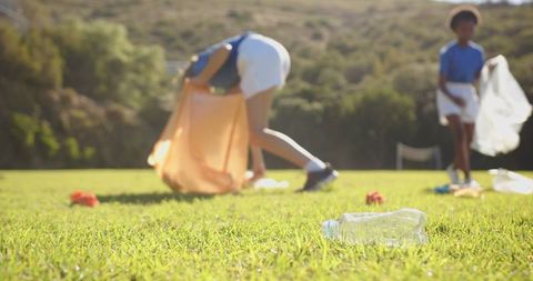 Students Picking Up Litter in Park for Environmental Awareness