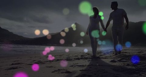 Romantic Couple Walking Hand in Hand on Twilight Beach