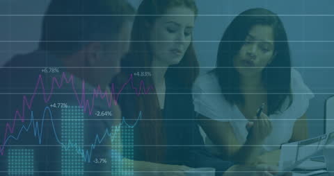 Diverse Business Team Analyzing Financial Data with Graph Overlays