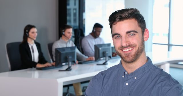 Happy Businessman with Call Center Team in Background - Download Free Stock Images Pikwizard.com