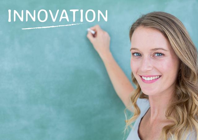 Cheerful woman writing the word 'innovation' on a chalkboard, smiling confidently. Ideal for educational materials, business presentations, motivational content, and creativity workshops. Perfect for illustrating concepts of innovation, teaching, and professional development.