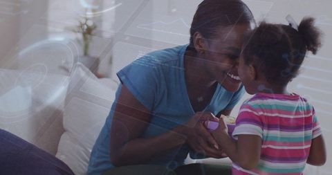 Mother and daughter sharing tender moment on sofa, bonding and caregiving at home
