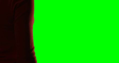 Woman's hand gesturing against bright green background