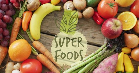Rustic flat-lay featuring colorful superfoods and fresh produce with painted SUPER FOODS label