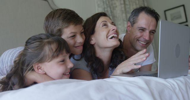 Happy Family Enjoying Leisure Time with Laptop Together - Download Free Stock Images Pikwizard.com