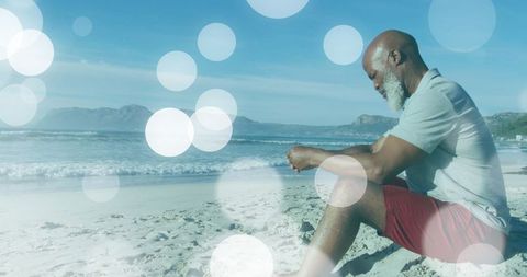 Senior Man Contemplating Peacefully by Seaside Sparks Serenity