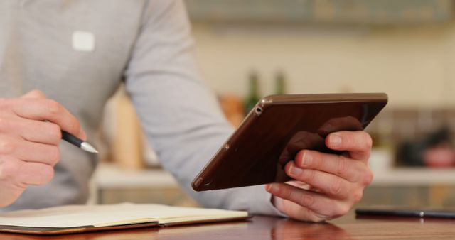 Young Professional Using Tablet and Taking Notes in Cozy Home Office - Download Free Stock Images Pikwizard.com