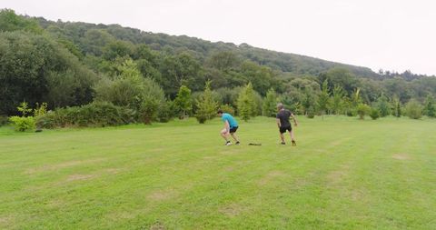 Two Men Jogging in Green Park Setting Amidst Lush Nature - Download Free Stock Images Pikwizard.com