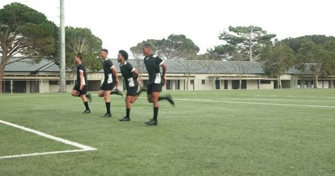 Diverse soccer team warming up on field during training