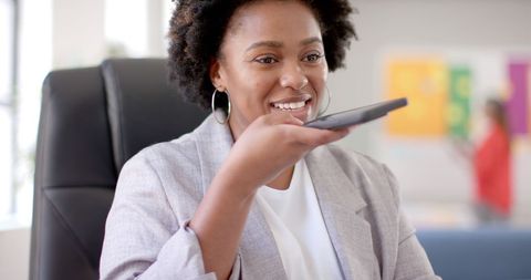 African American Businesswoman Using Smartphone in Office