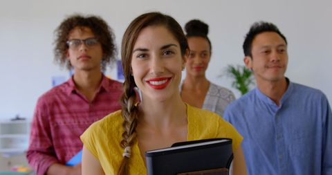 Diverse team standing confidently in modern office atmosphere