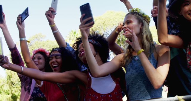 Excited Group of Friends Taking Selfies at Outdoor Festival - Download Free Stock Images Pikwizard.com