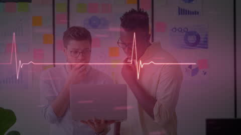 Cardiograph Overlay on Business Discussion with Laptop