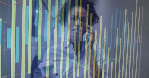 Businesswoman Analyzing Data While on Phone in Office Environment