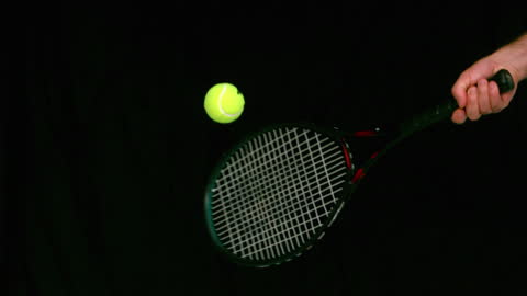 Tennis Ball Bouncing on Racket in Slow Motion Captivates Focus