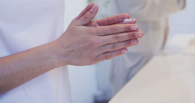 Close-up of Person Applying Hand Cream in Modern Bathroom - Download Free Stock Images Pikwizard.com