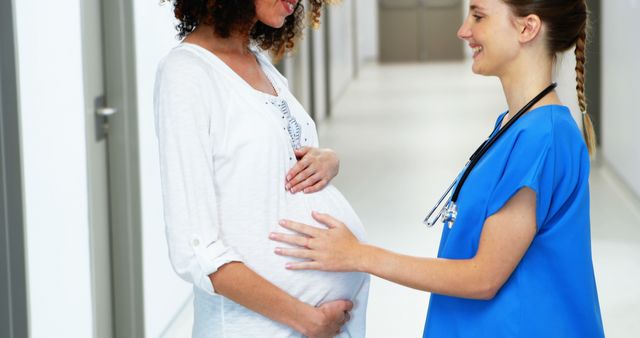 Pregnant Woman Consulting with Nurse in Hospital Hallway - Download Free Stock Images Pikwizard.com