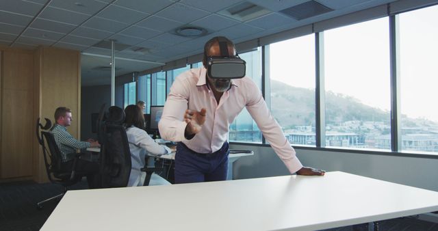 Businessman Wearing VR Headset Engaging in Augmented Reality Experience in Modern Office - Download Free Stock Images Pikwizard.com