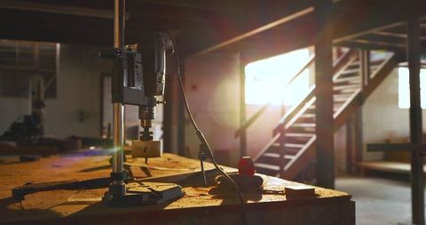 Sunlit Workshop with Drill Press on Workbench