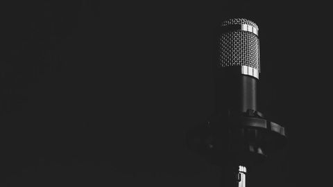 Microphone in dark studio setting captured in monochrome