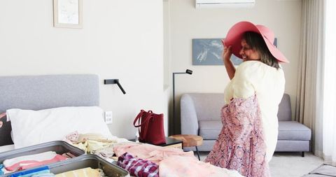 Joyful Senior Couple Packing with Excitement for Vacation