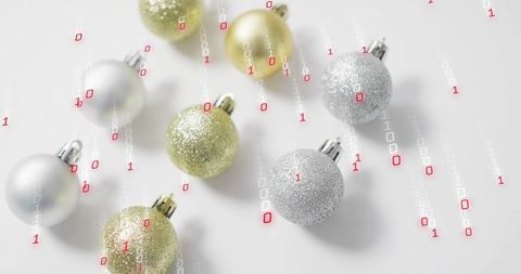 Mixing metallic gold and silver baubles with falling binary code for tech holiday concept